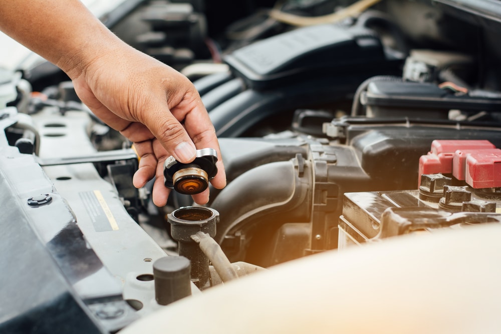 Man checking fluid levels in his engine