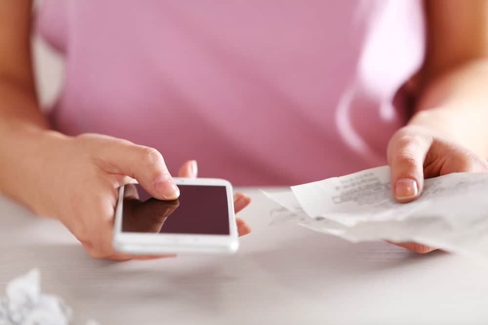 Woman checking her mobile phone bill