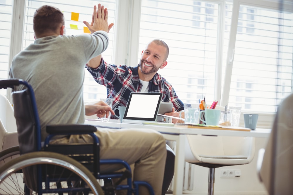 Disabled men high fiving