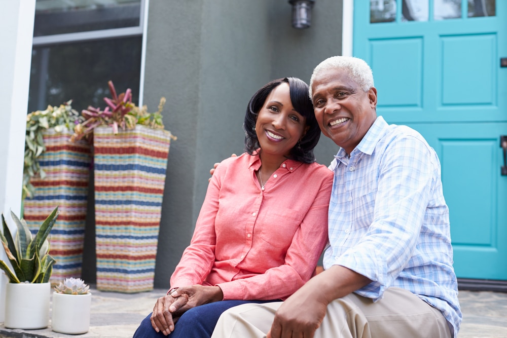 Older couple in front of their home/Front Door