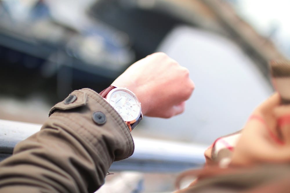 woman checking time on a wrist watch