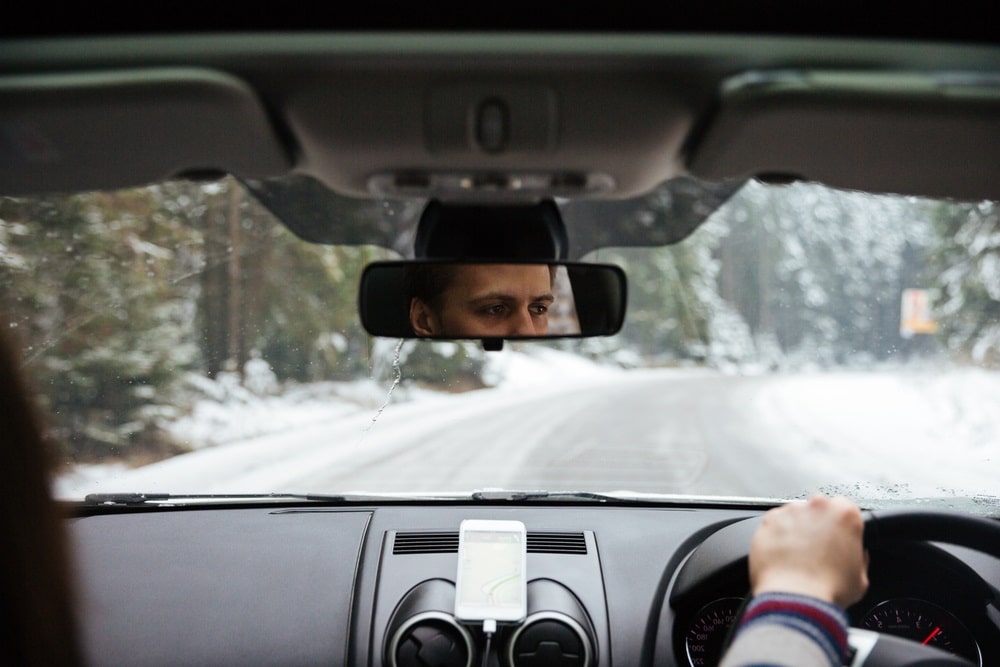 Man driving car on snowy road