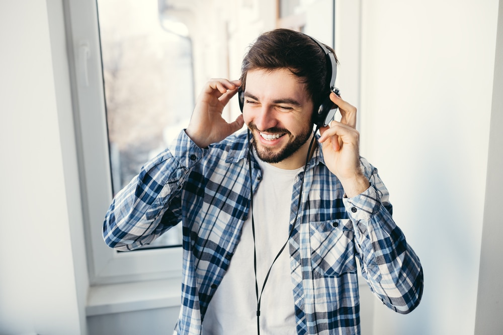 Happy man listening to music on headphones