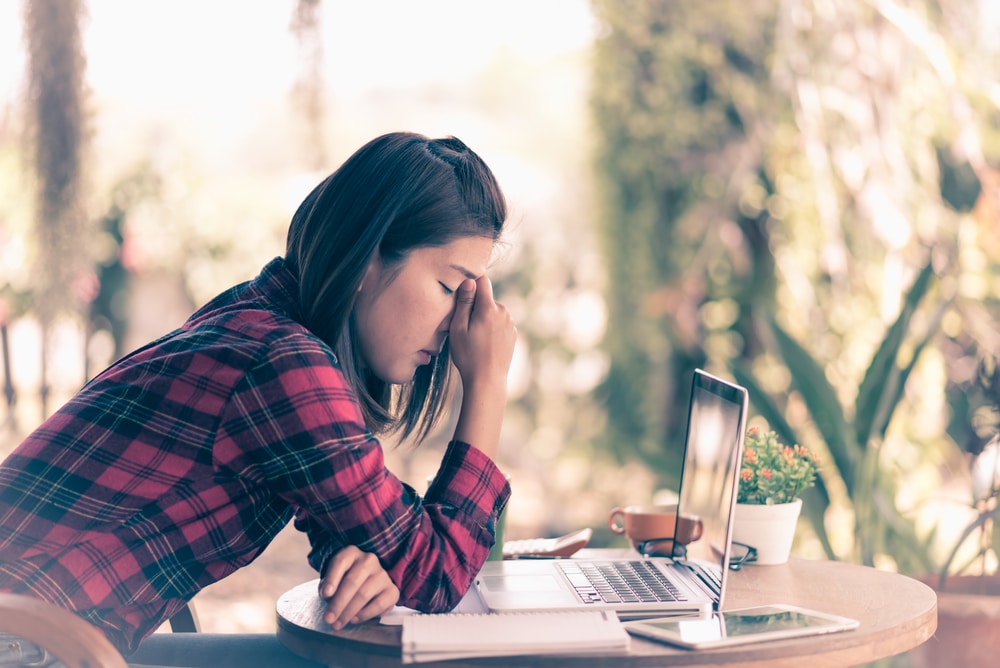 Unhappy woman sat at her desk