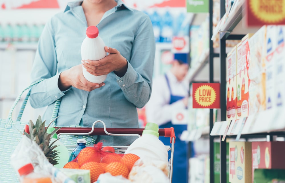 Woman looking at supermarket offers