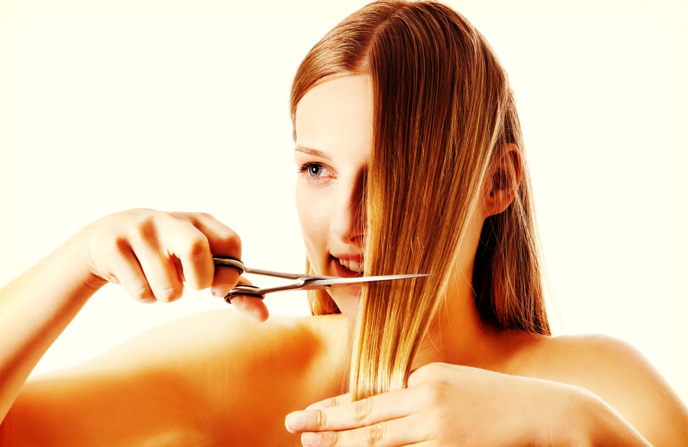 Woman cutting her hair