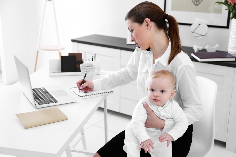 Working mother holding a baby